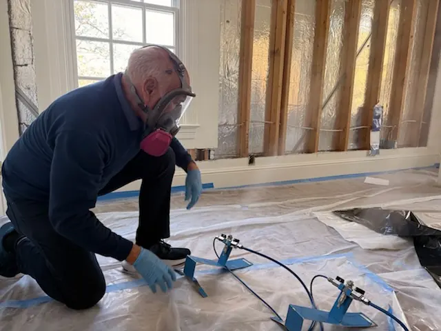 A restoration technician setting drying equipment in a Chula Vista home stripped to the studs